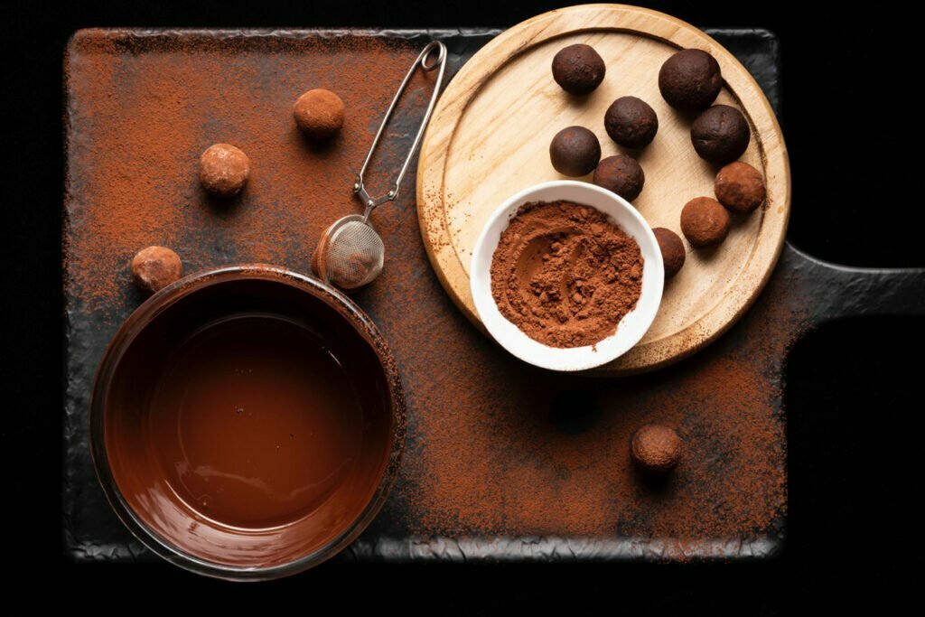 Chocolate truffles decorated with chocolate dust.